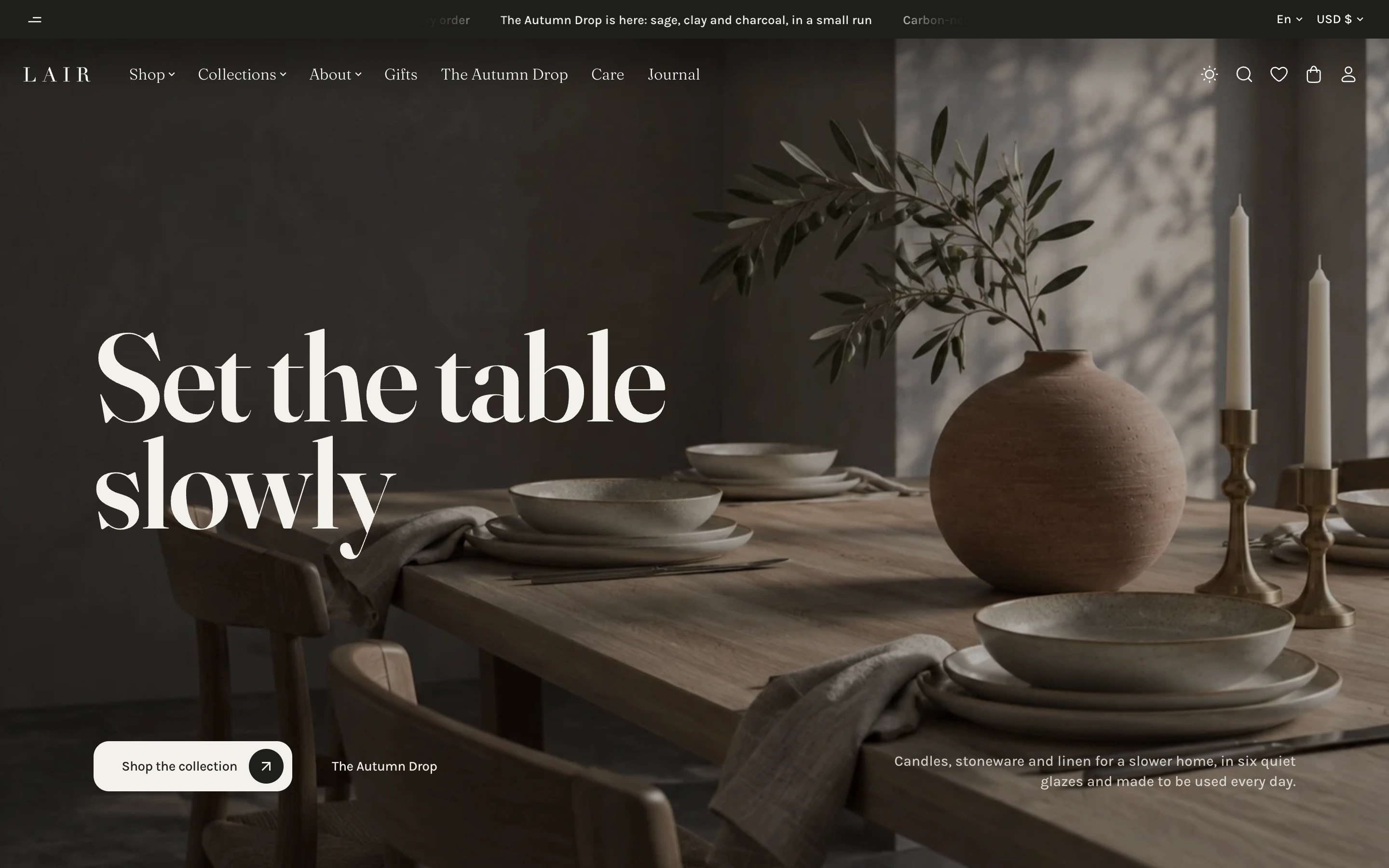Home page of the Lair style, a home goods shop, with the heading Set the table slowly over a dark photo of a dining table